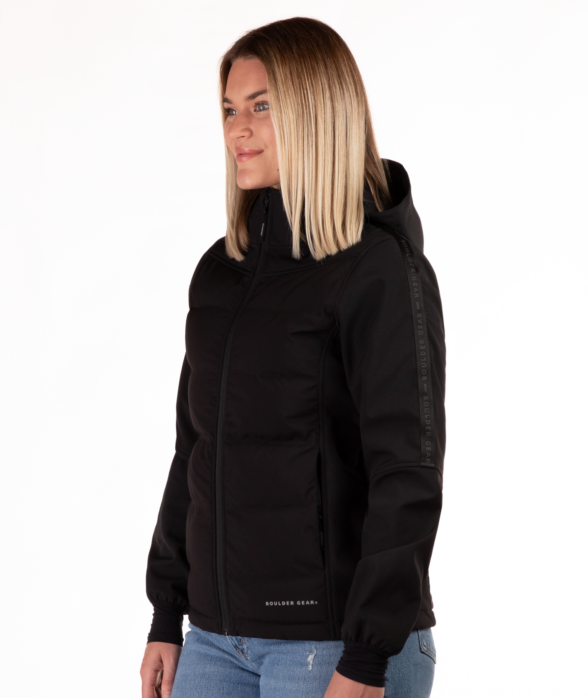 Woman wearing a black jacket with a hood highlighting the sleeve detail on a white background