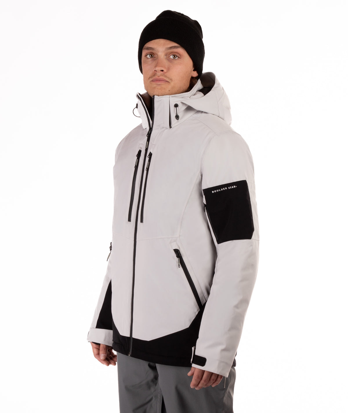 Person wearing a light gray and black jacket with a hood on a white background