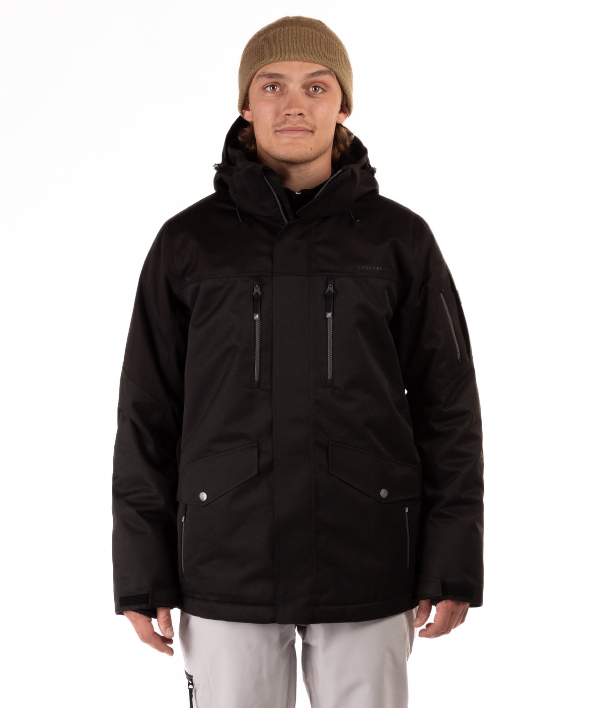 Person wearing a black jacket with chest pocket zippers on a white background
