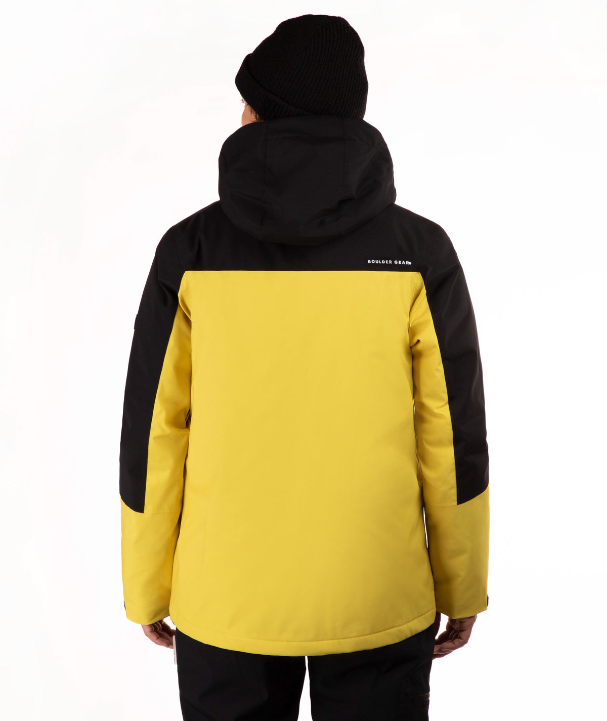 A person shown from the back wearing a colorblock ski jacket in yellow and black, paired with a black beanie and black pants, against a plain white background.
