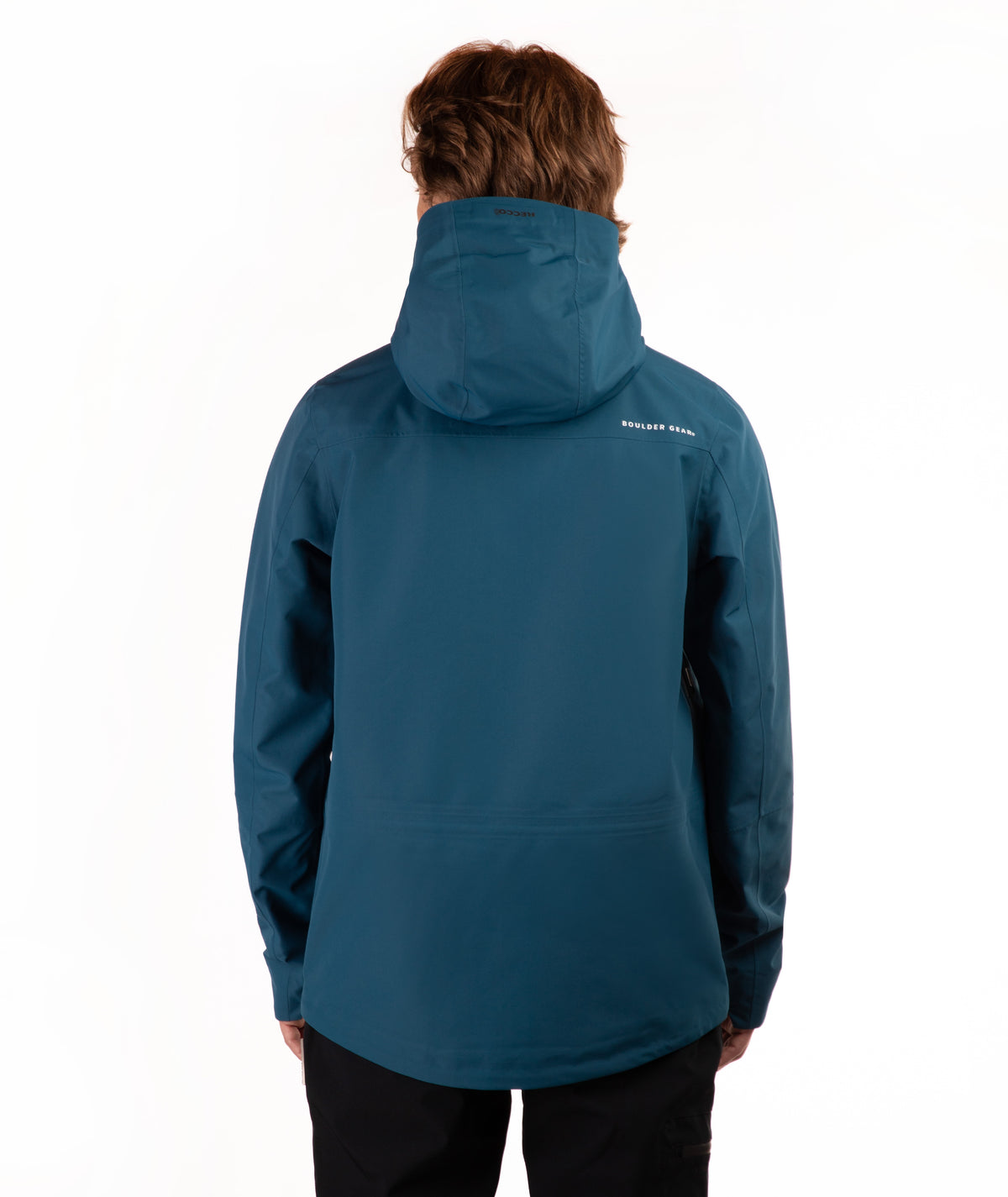 A person shown from the back wearing a teal hooded jacket and black pants against a plain white studio background.