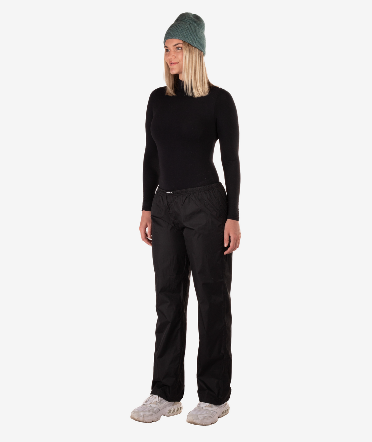 Person wearing a black rain pants on a white background