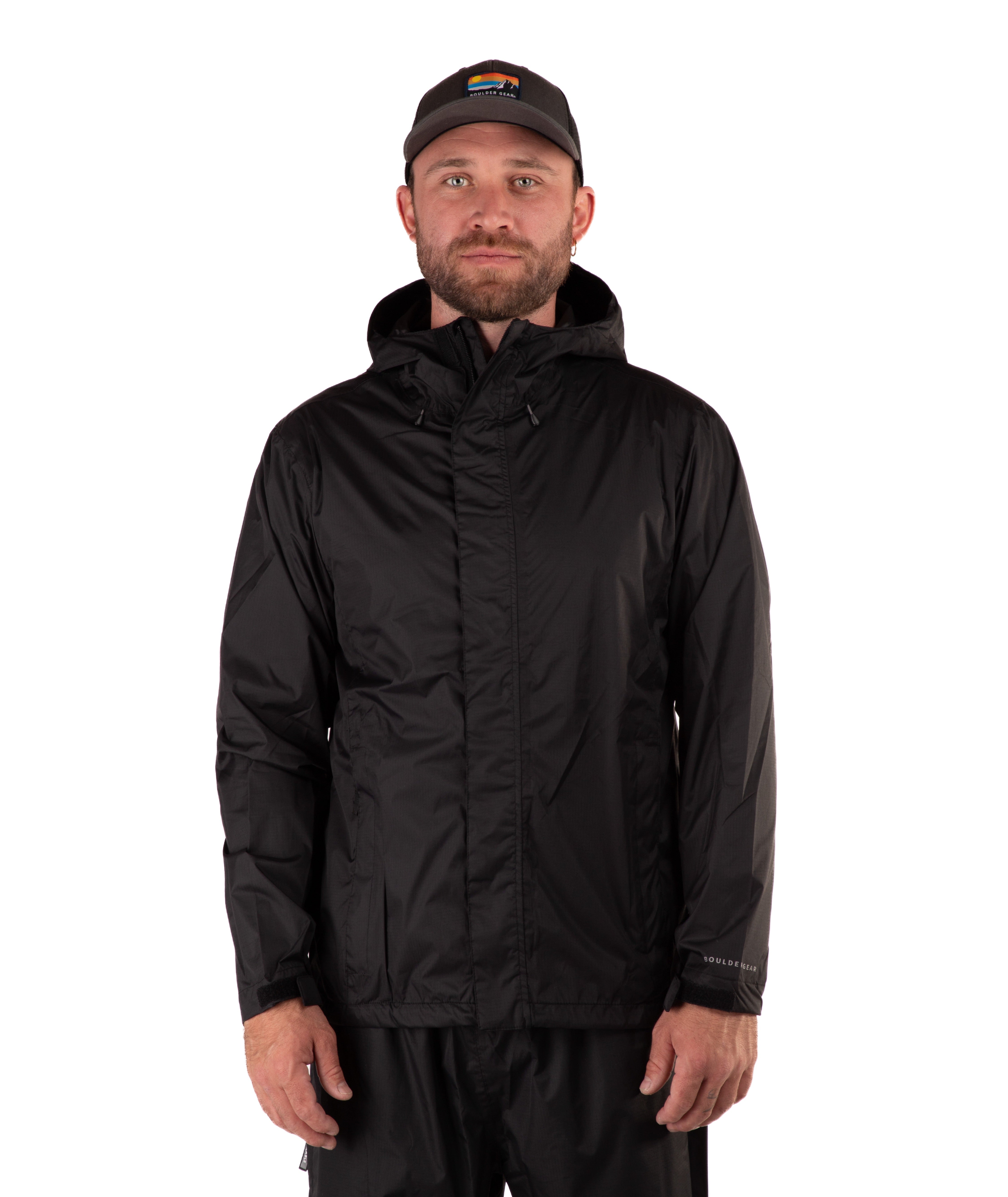 Man wearing a black raincoat and cap on a white background
