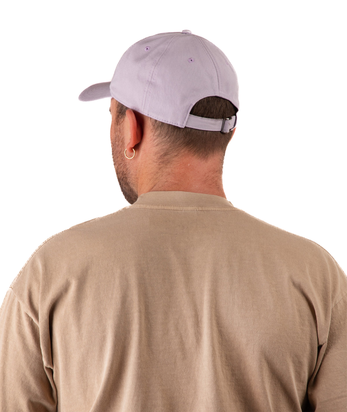 back of a Man wearing a light purple cap and beige shirt on a white background