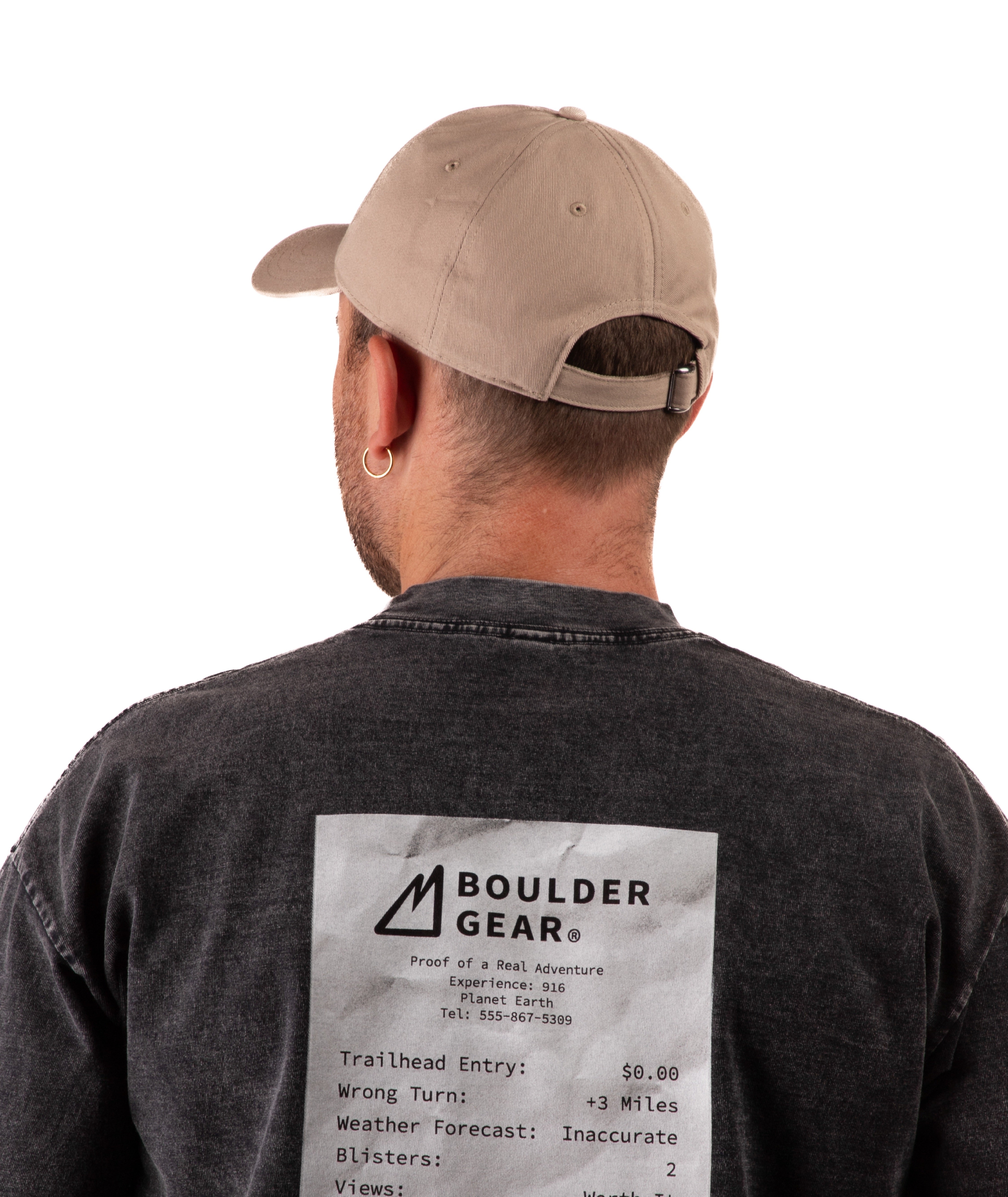 back of a Man wearing a black Boulder Gear T-shirt and khaki cap on a white background