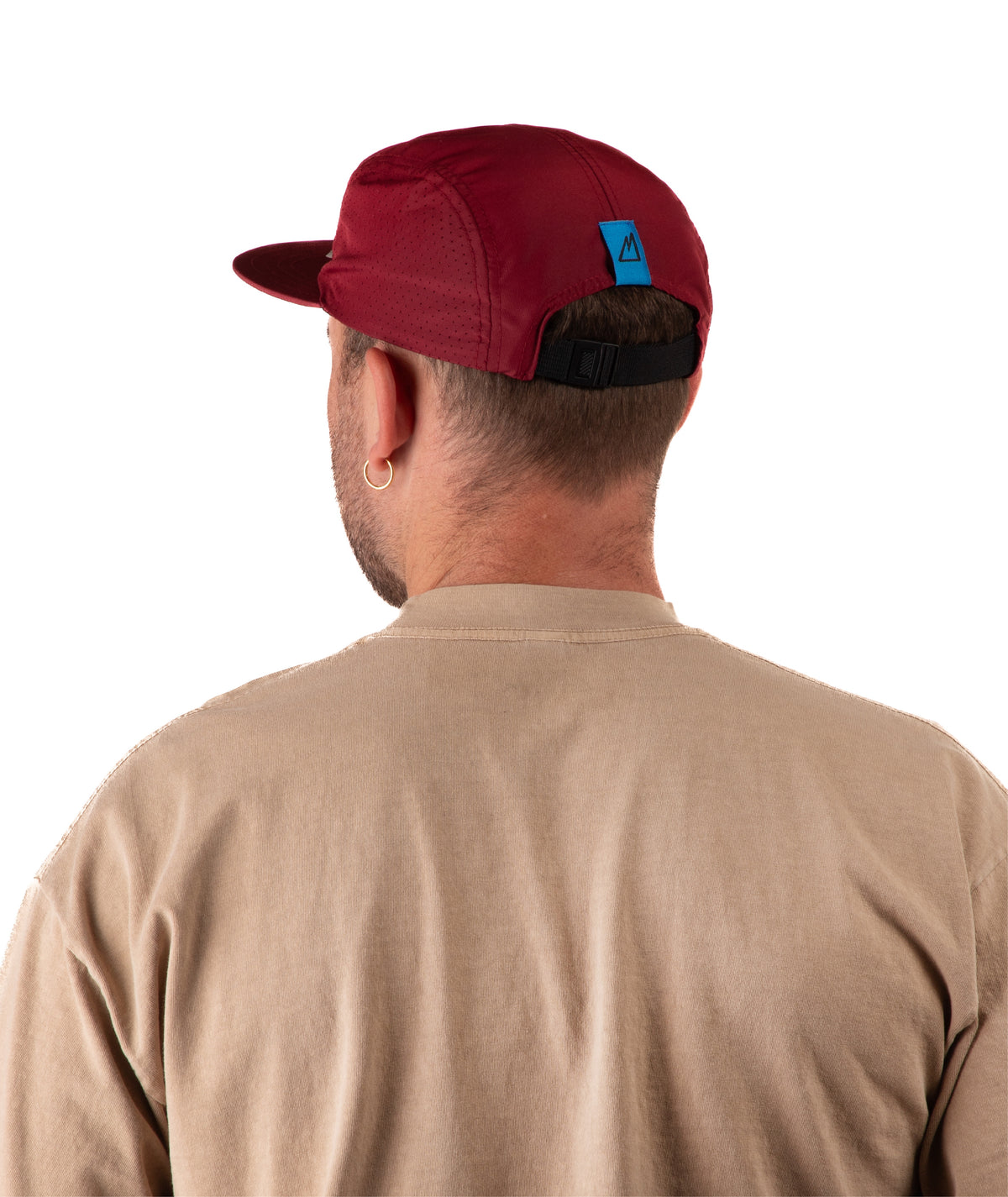 back of Man wearing a beige t-shirt and a maroon cap on a white background
