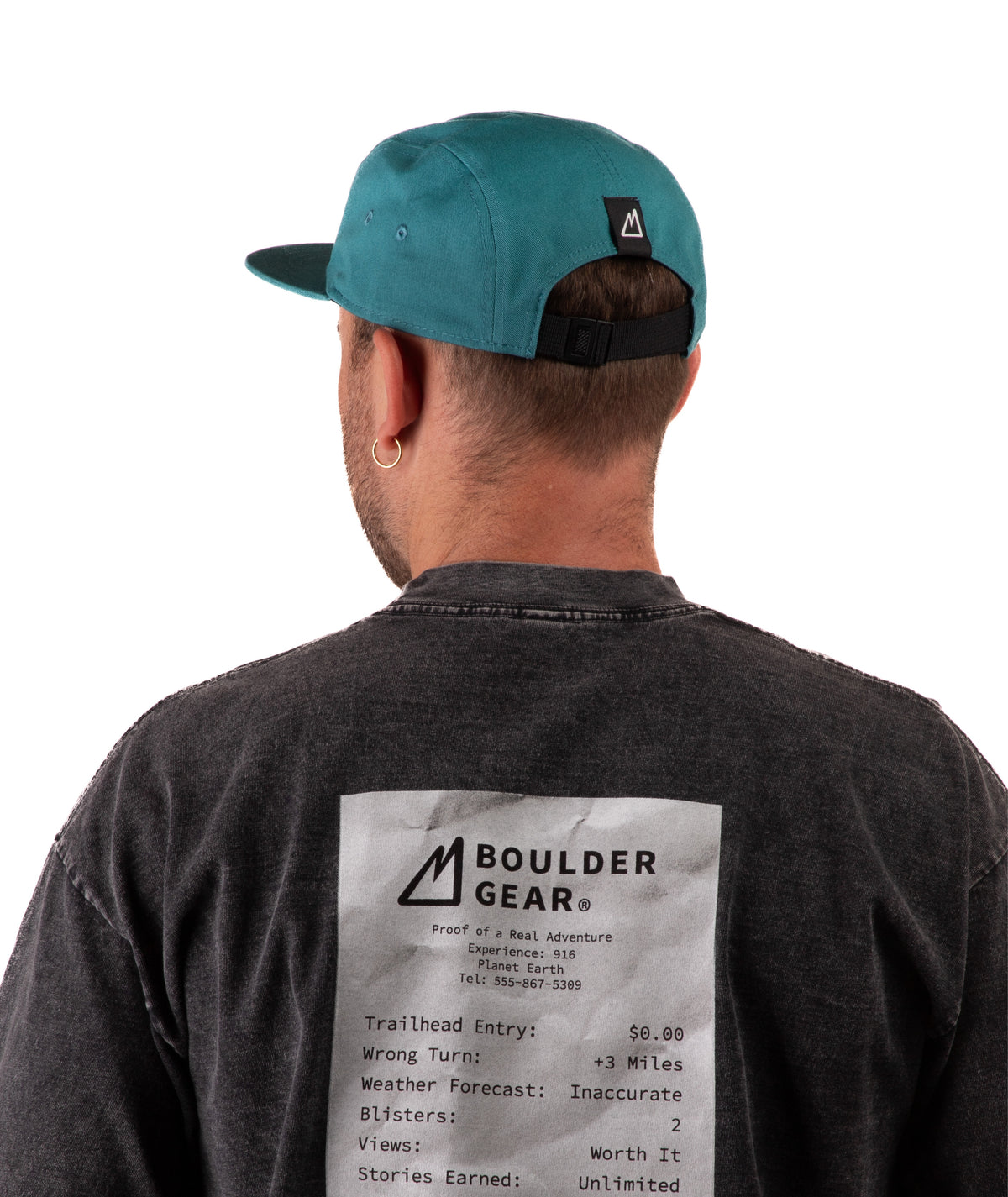 back of a Man wearing a black T-shirt and green cap with 'Boulder Gear' logo on a white background