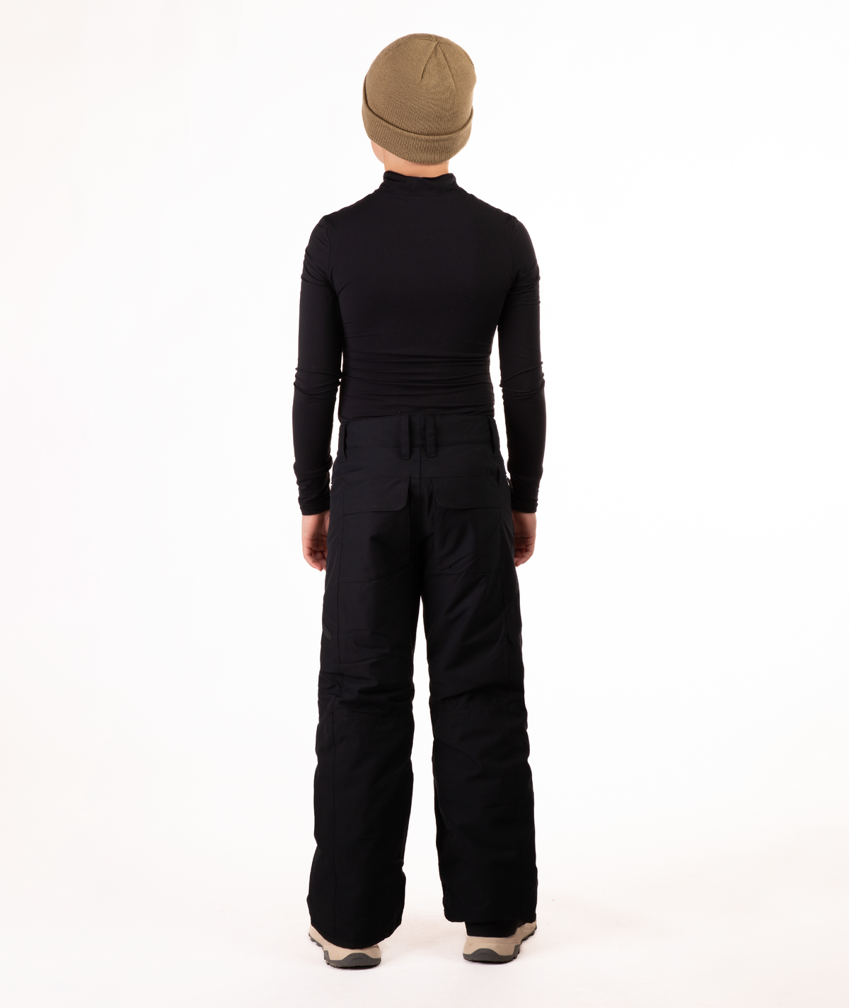 back of youth boy wearing a black long-sleeve shirt and black snow pants on a white background