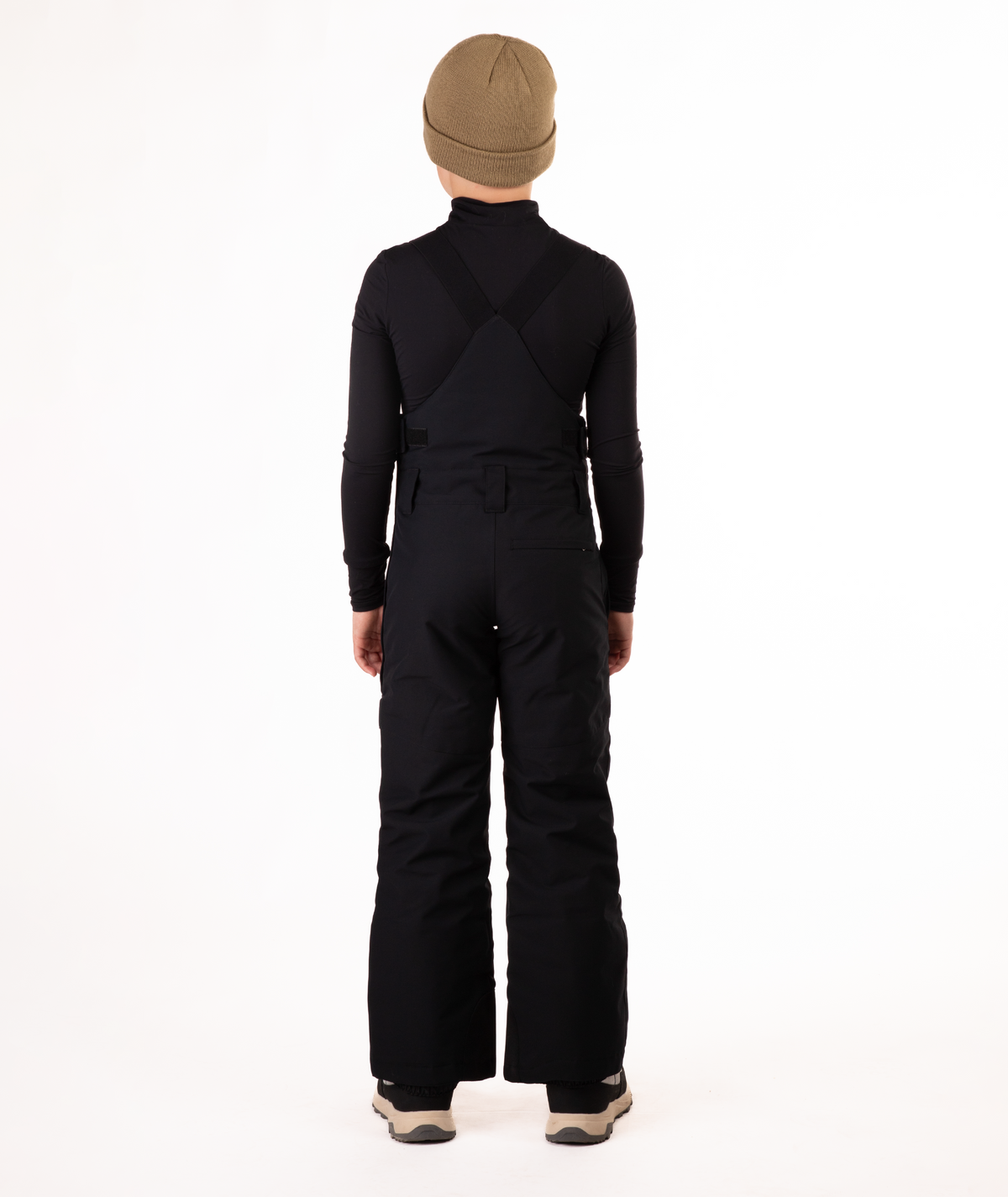 back of boy wearing black bibs and black top on a white background