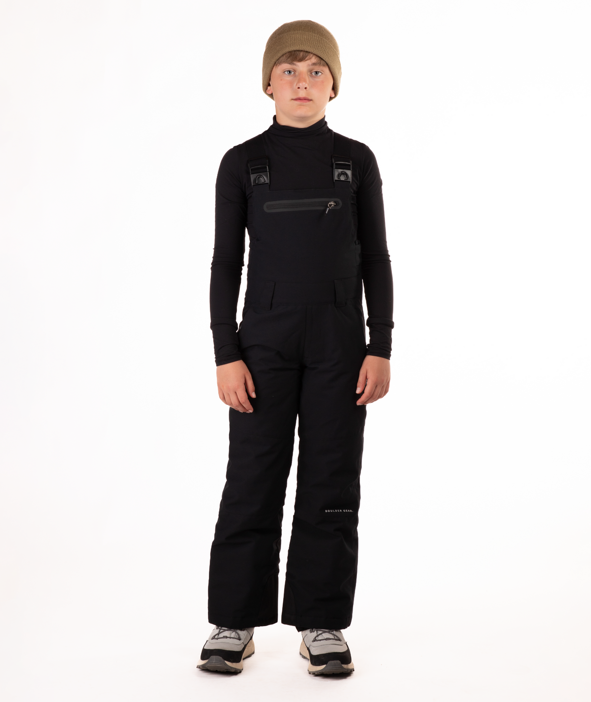 boy wearing black bibs and black top on a white background