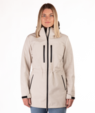 Woman wearing a beige jacket with black accents on a white background