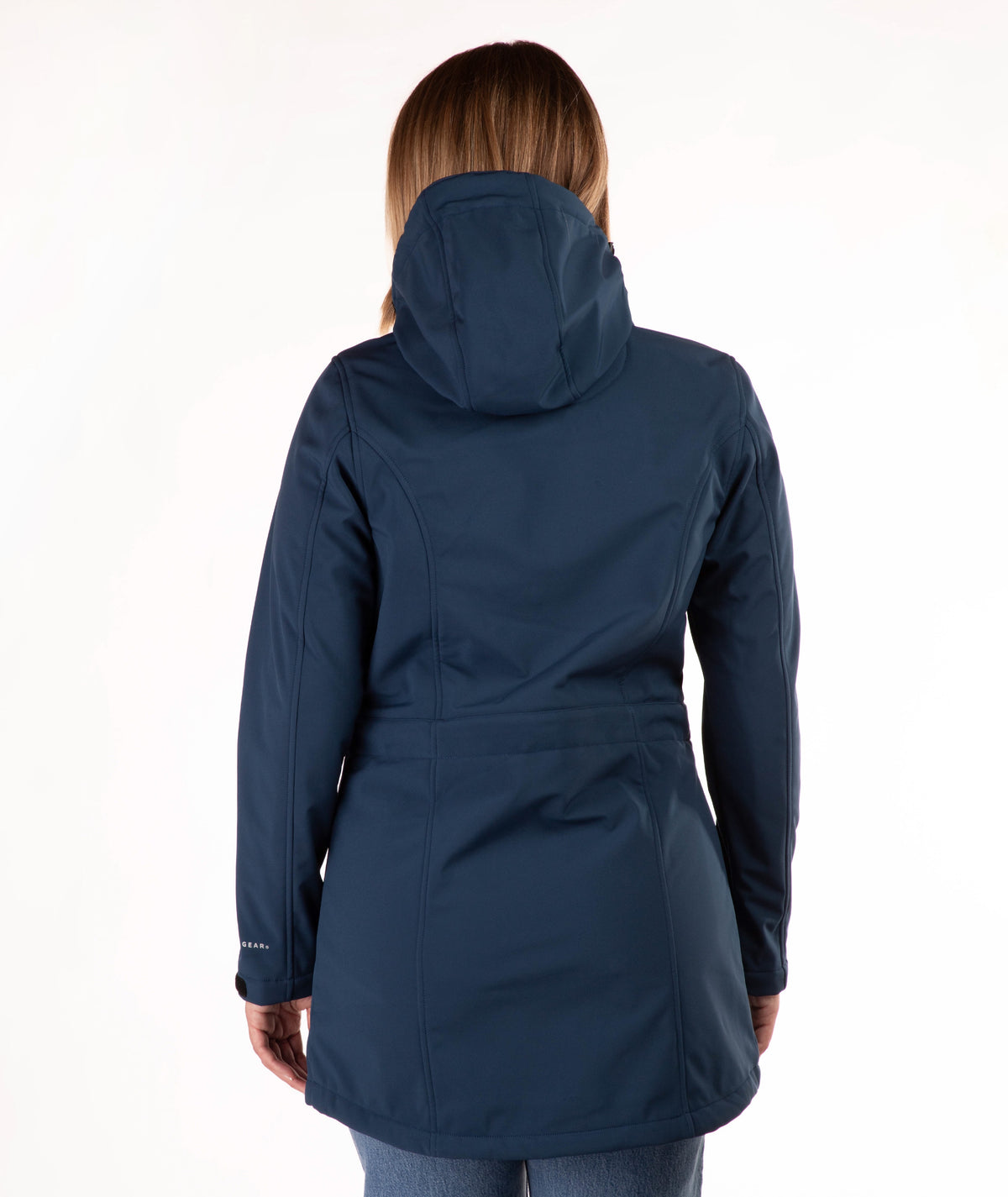 A woman viewed from the back wearing a dark navy hooded jacket against a plain white studio background.