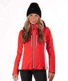 Woman wearing a red and black ski jacket on a white background