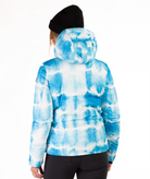 Woman wearing a blue and white tie-died pattern jacket on a white background highlighting the back of the jacket