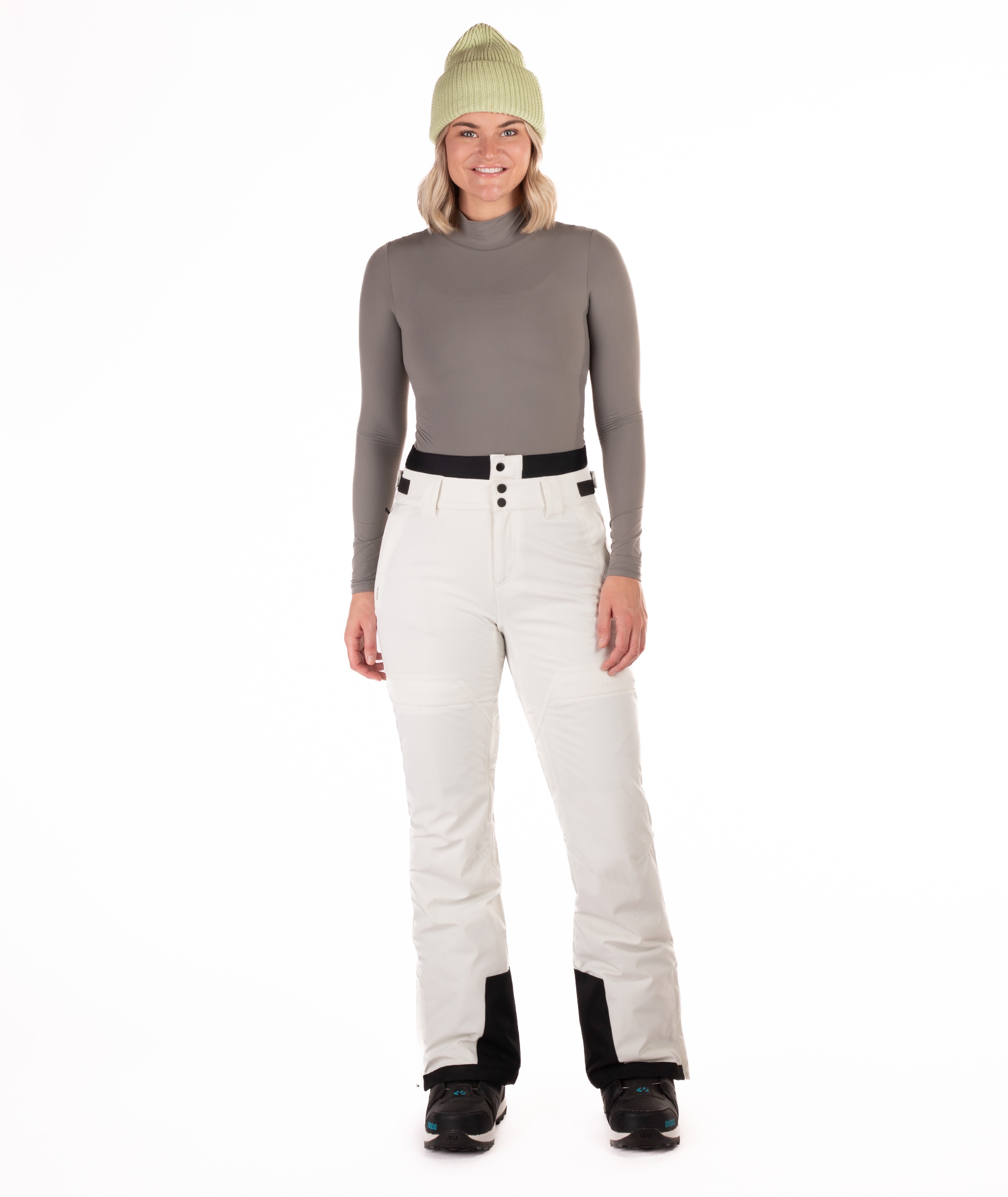Person wearing off white colored pants on a white background