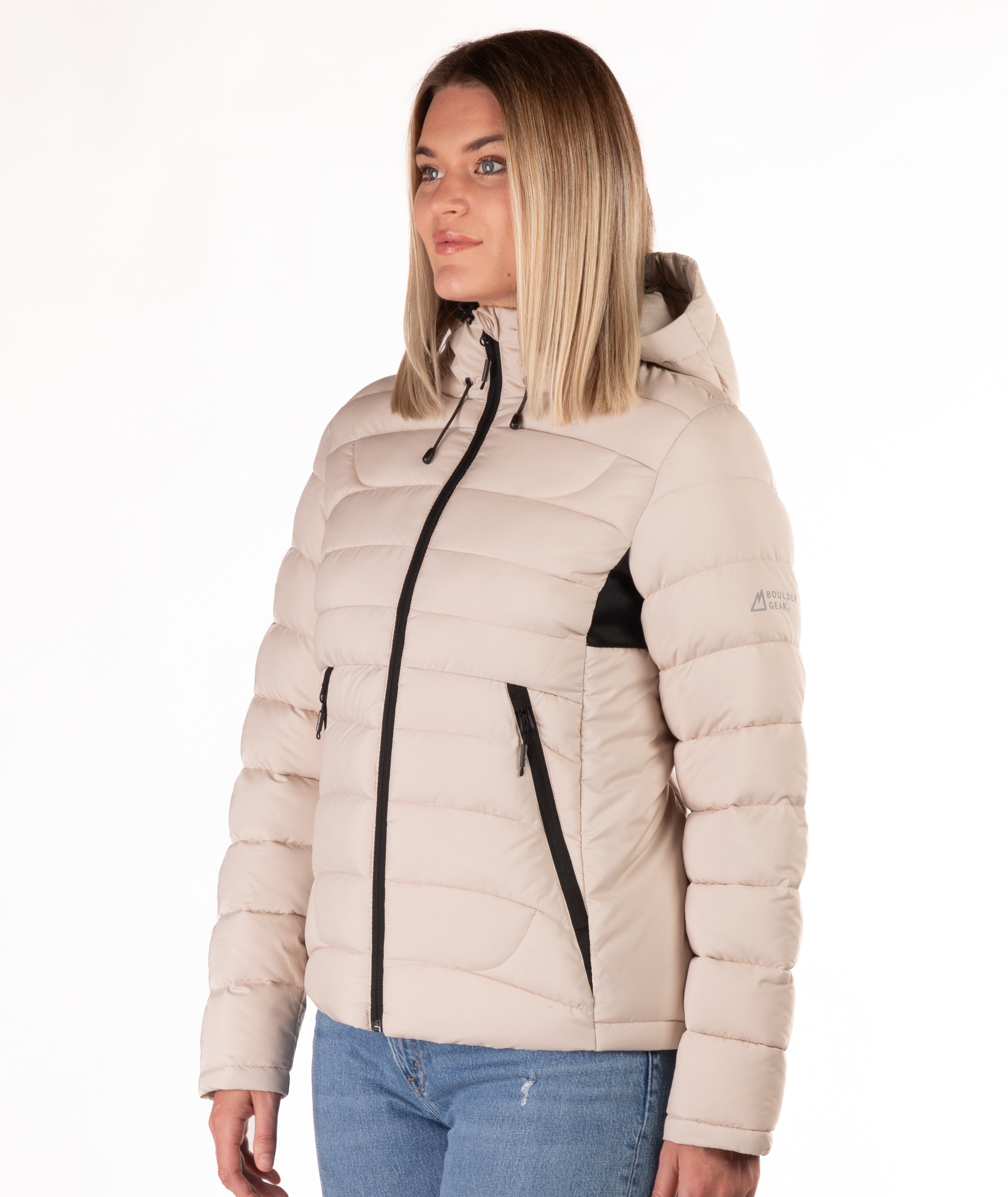 Woman wearing a beige puffer jacket with a black zipper on a white background