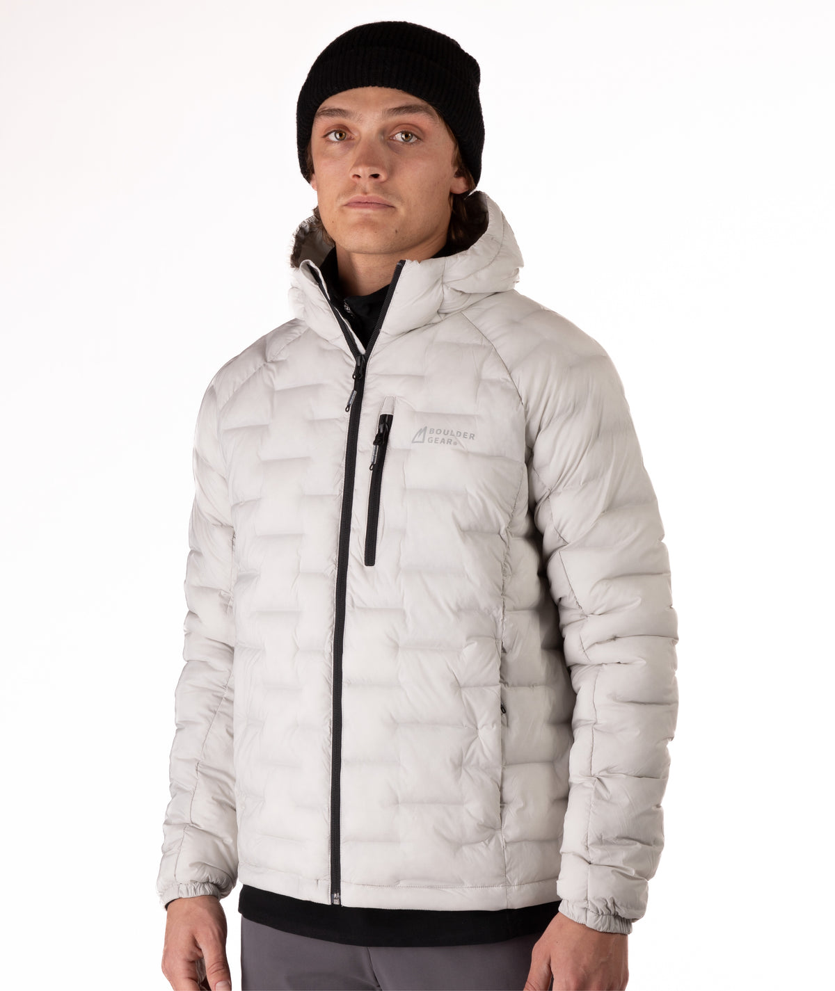 Person wearing a light gray jacket with a black zipper on a white background