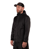 Man wearing a black raincoat and cap on a white background