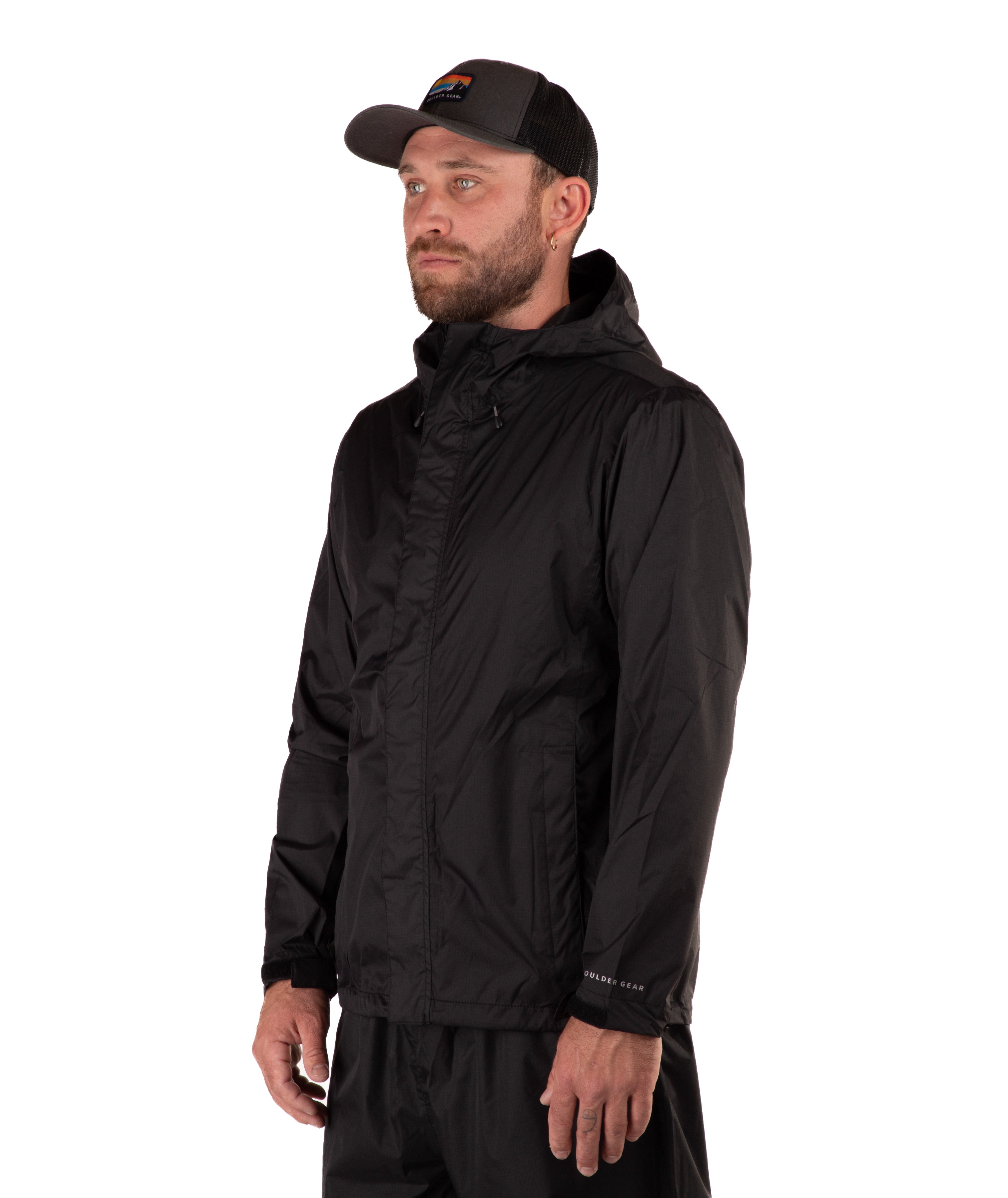 Man wearing a black raincoat and cap on a white background