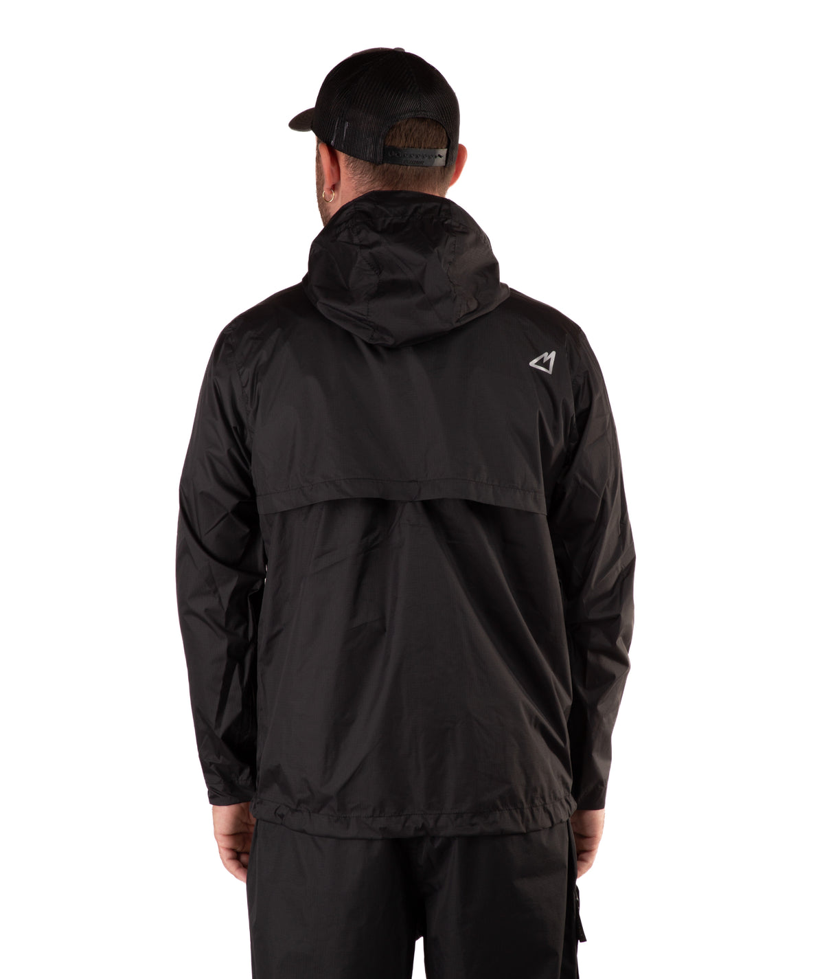 back of a Man wearing a black raincoat and cap on a white background