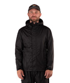 Man wearing a black raincoat and cap on a white background