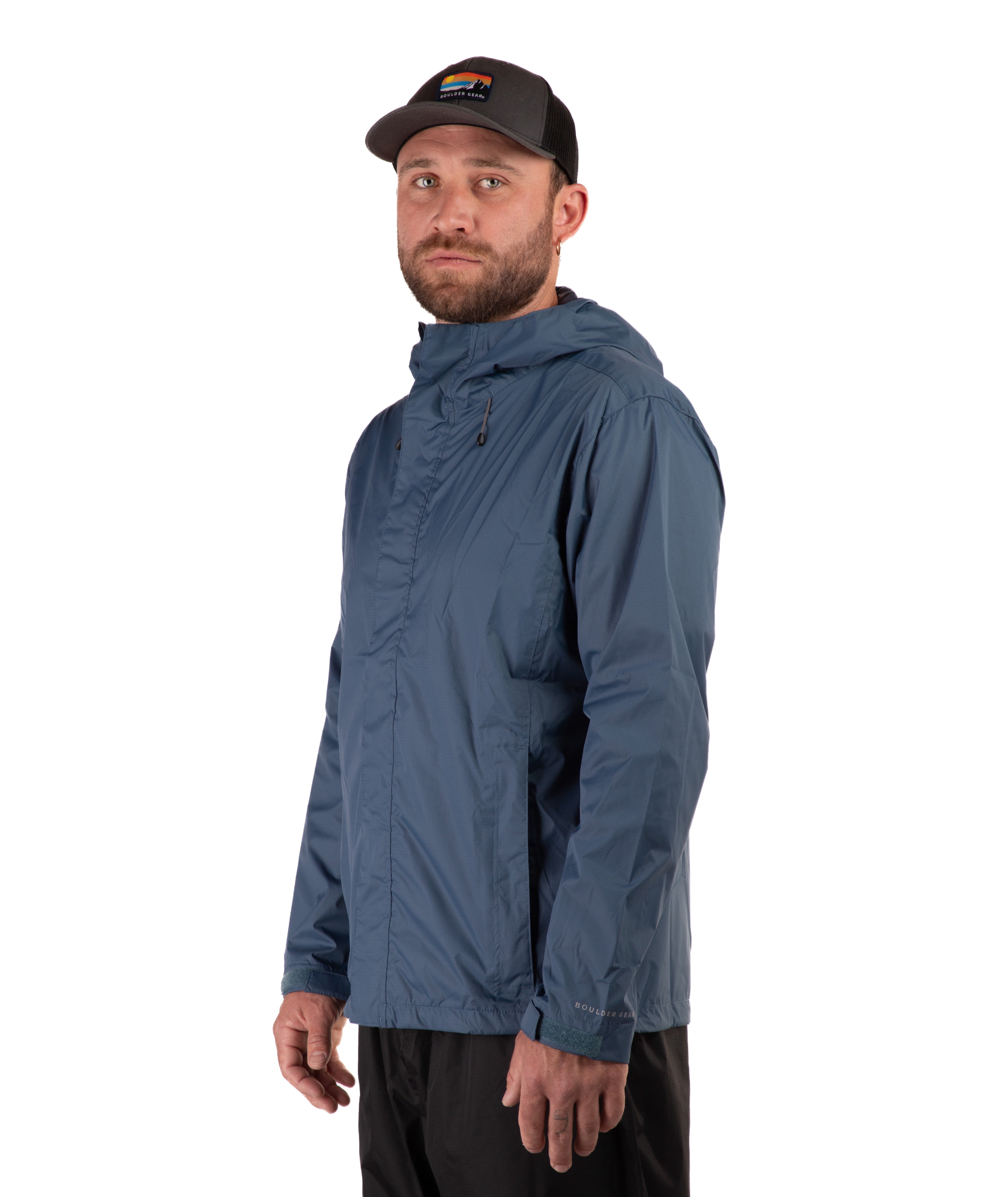 Man wearing a blue rain jacket and black cap on a white background