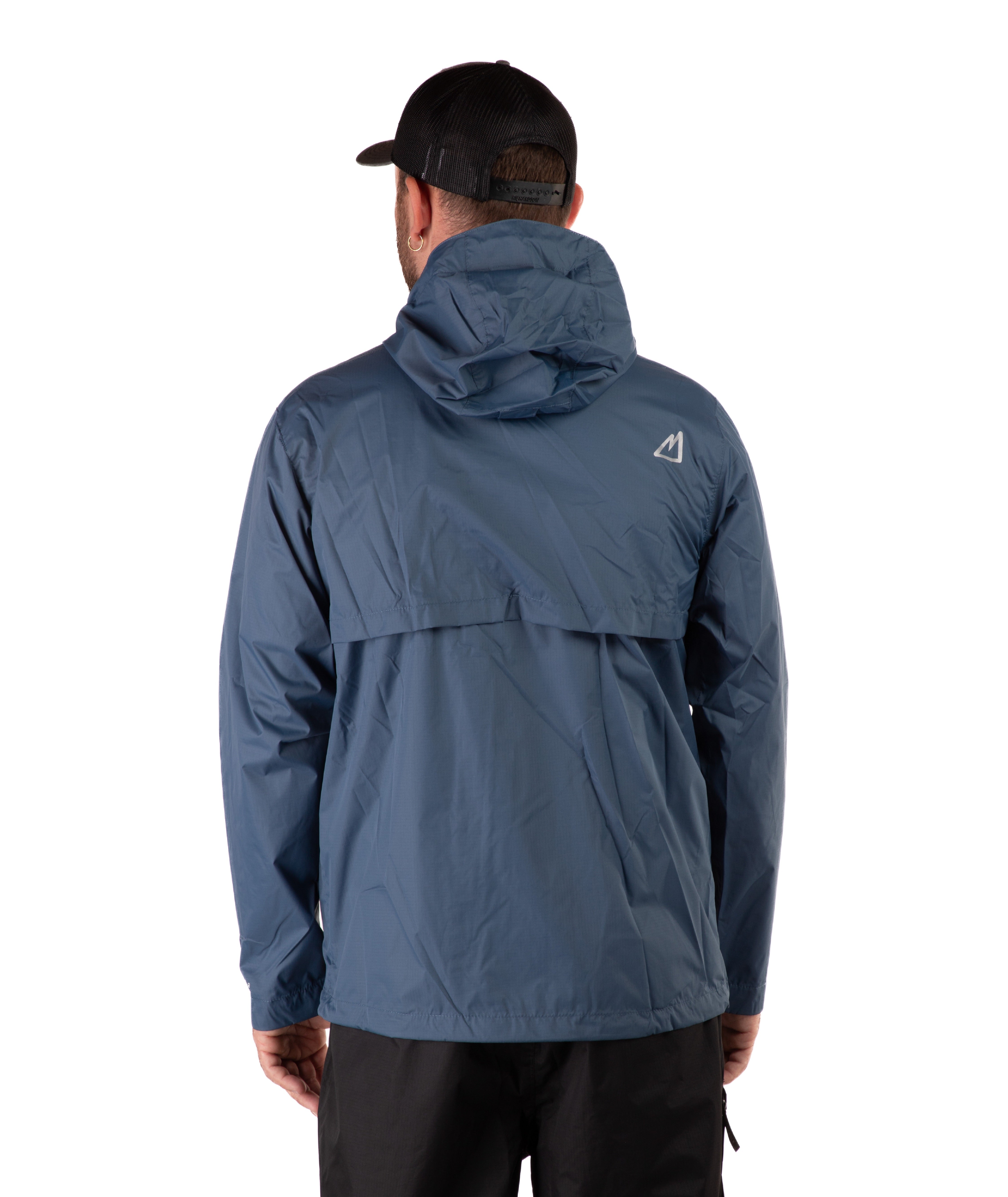 Person wearing a blue rain jacket with a brand logo on the back, standing against a white background