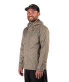 Man wearing a beige raincoat and black cap on a white background