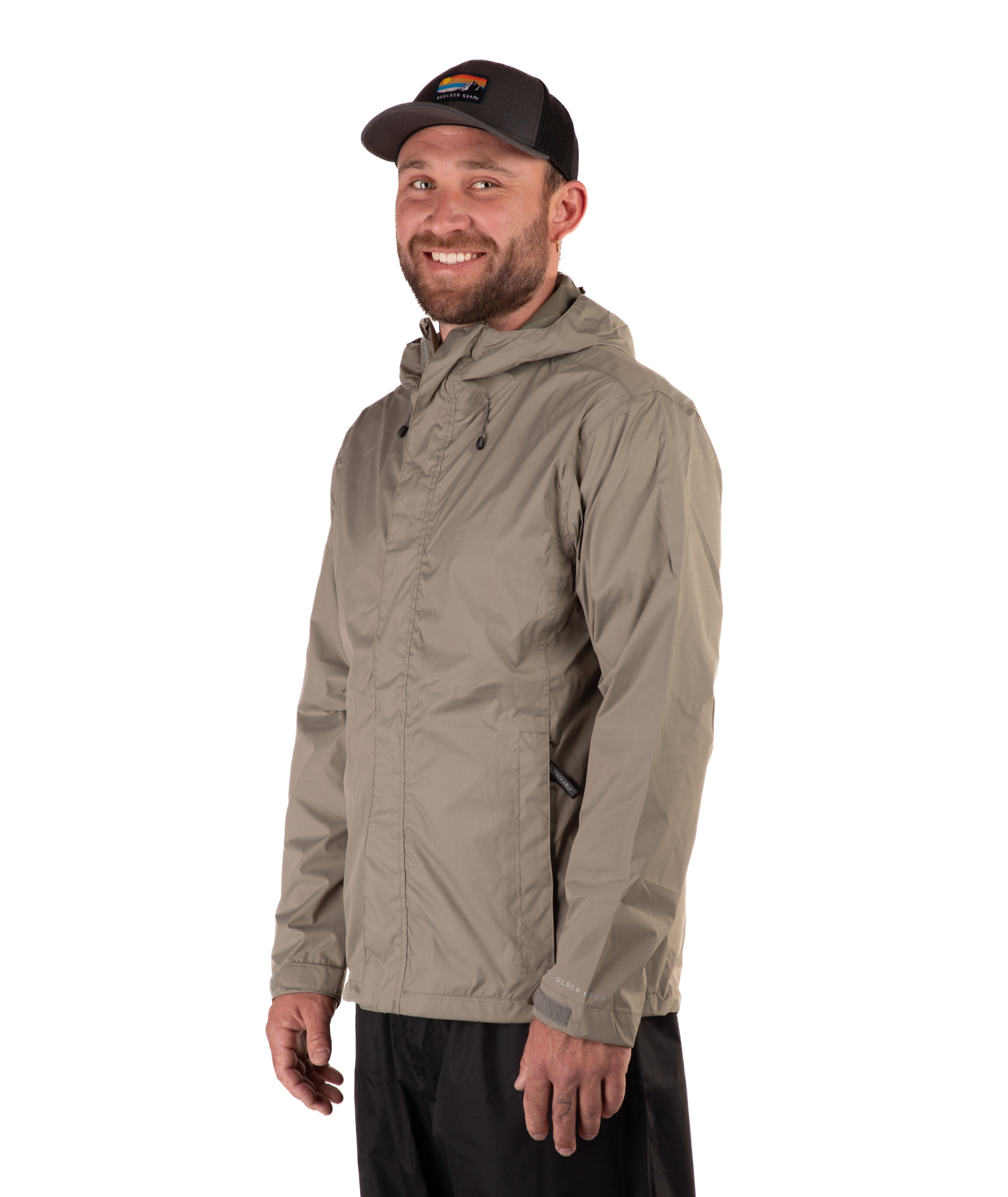 Man wearing a beige raincoat and black cap on a white background
