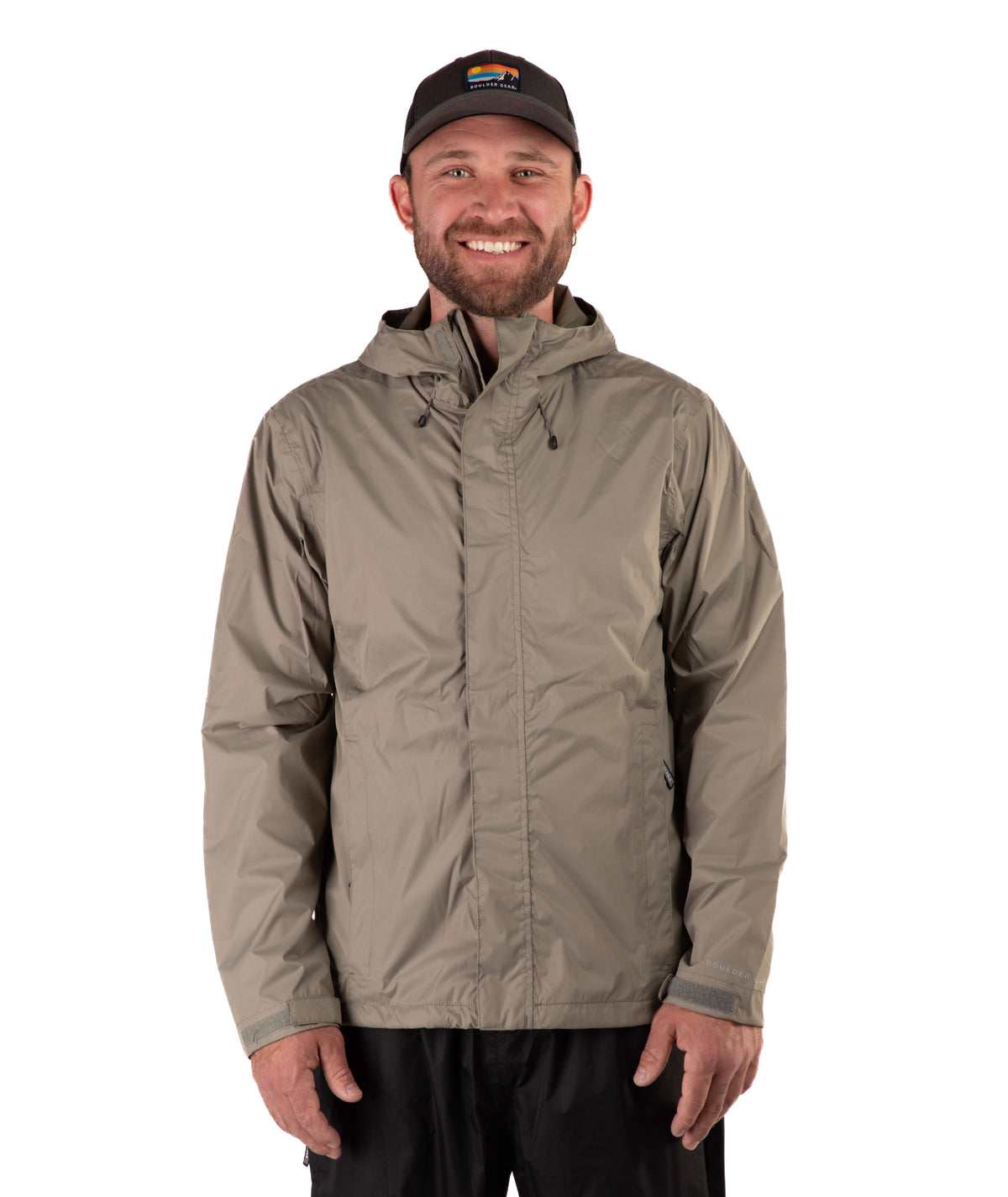 Man wearing a beige raincoat and black cap on a white background