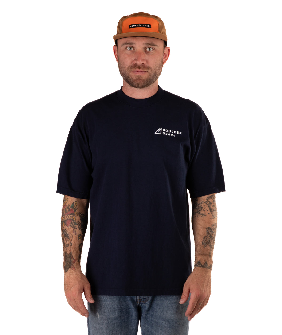 Man wearing a navy t-shirt with a logo and a brown cap on a white background