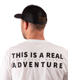 back of a Man wearing a navy cap and white t-shirt with text on a white background