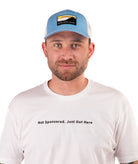 Man wearing a blue cap and white t-shirt with text on a white background