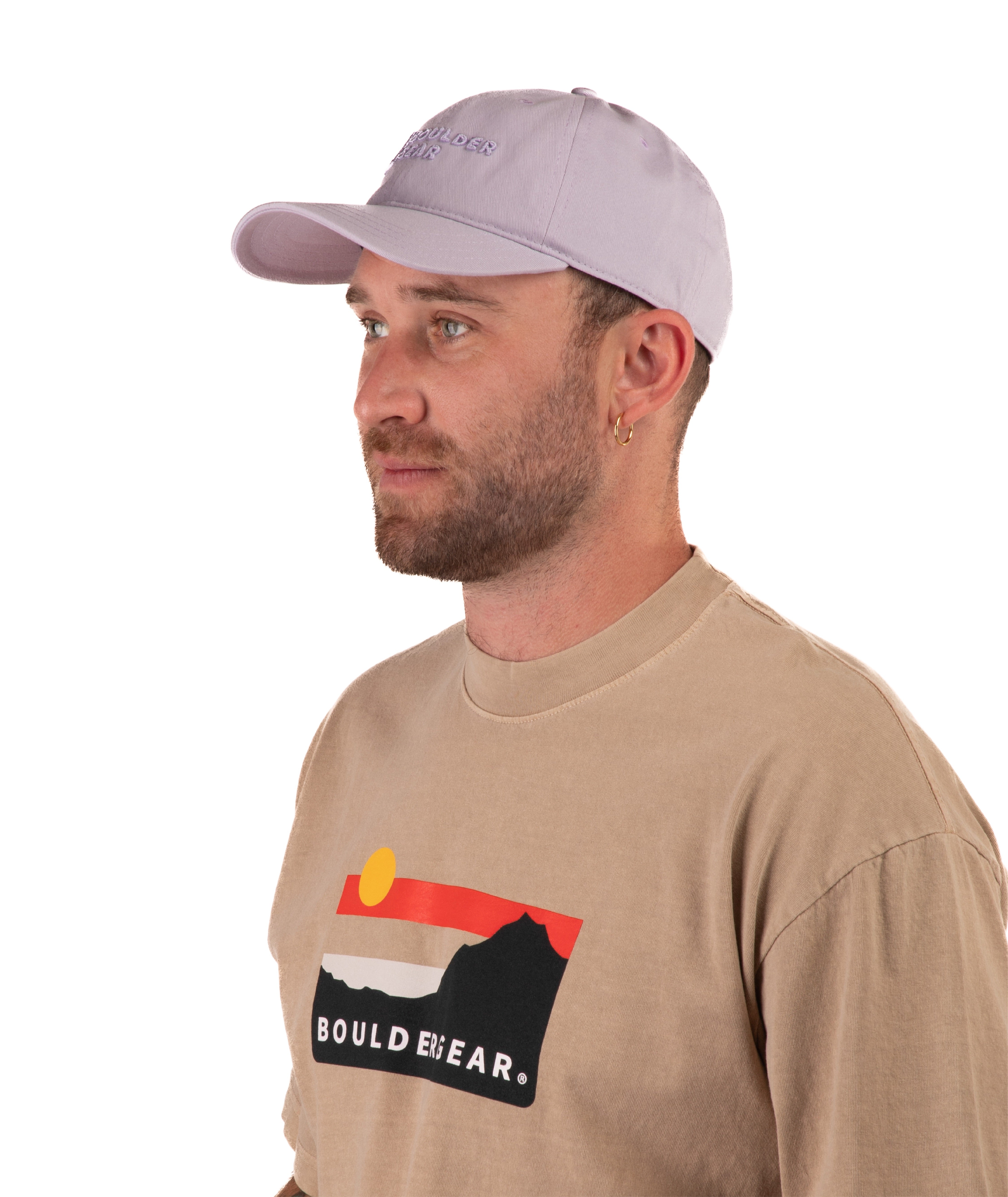 Man wearing a beige long-sleeve shirt with 'Boulder Gear' logo and a light purple cap on a white background