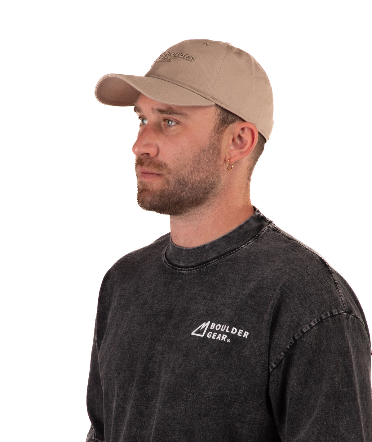 Man wearing a black Boulder Gear T-shirt and khaki cap on a white background