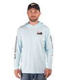 Man wearing a light blue long-sleeve hooded shirt with branding on a white background