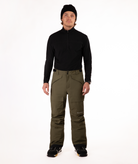 Person wearing a black shirt and green snow pants on a white background