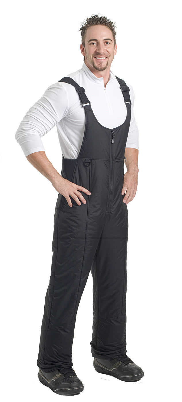 A man wearing a black snow bib on a white background