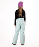 back of a girl wearing light blue snow pants and a black long-sleeve top on a white background