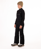 boy wearing black bibs and black top on a white background