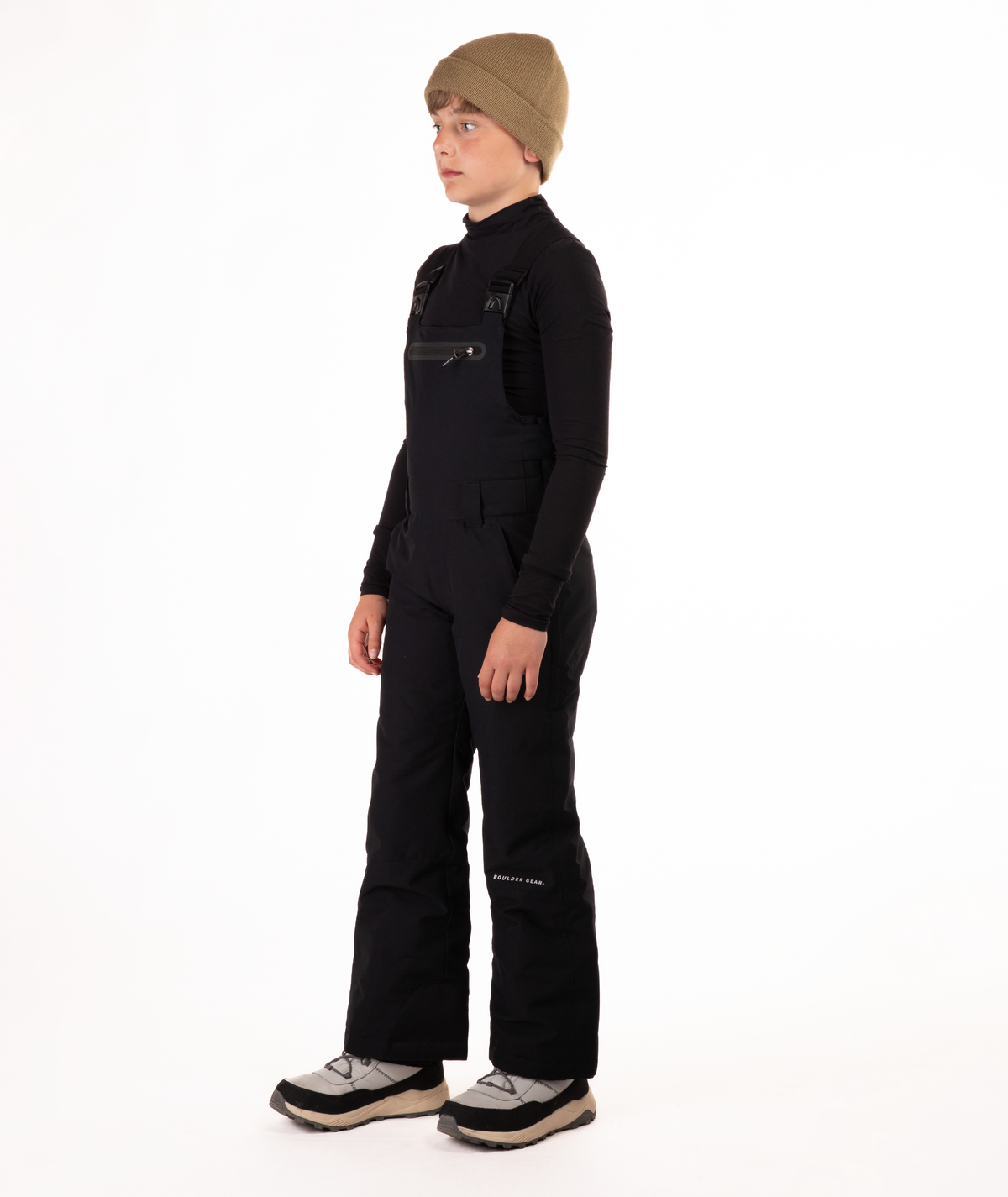 boy wearing black bibs and black top on a white background
