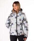 Woman wearing a flower patterned jacket on a white background